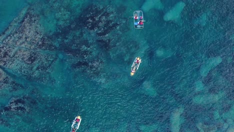 a couple who paddle and distance themselves among several boats