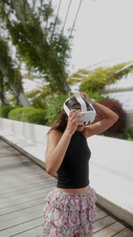 woman wearing vr headset in a park