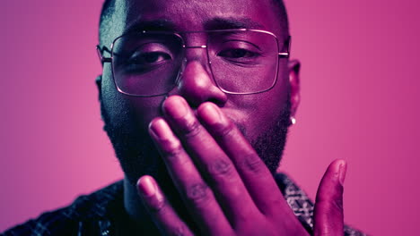 African-american-guy-sending-kisses-in-studio.-Afro-guy-staring-at-lense-indoors