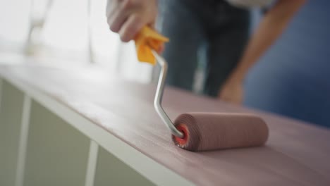 Close-up-video-of-painting-old-furnitures-with-a-roller.