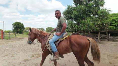 llanero riding a horse on a dusty ranch under a bright sky, calm and traditional scene