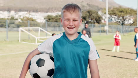 young boy with soccer ball on a field