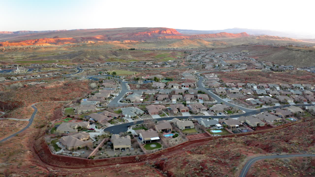 Aerial View of a Residential Neighborhood in a Desert Landscape with Red Rock Mountains