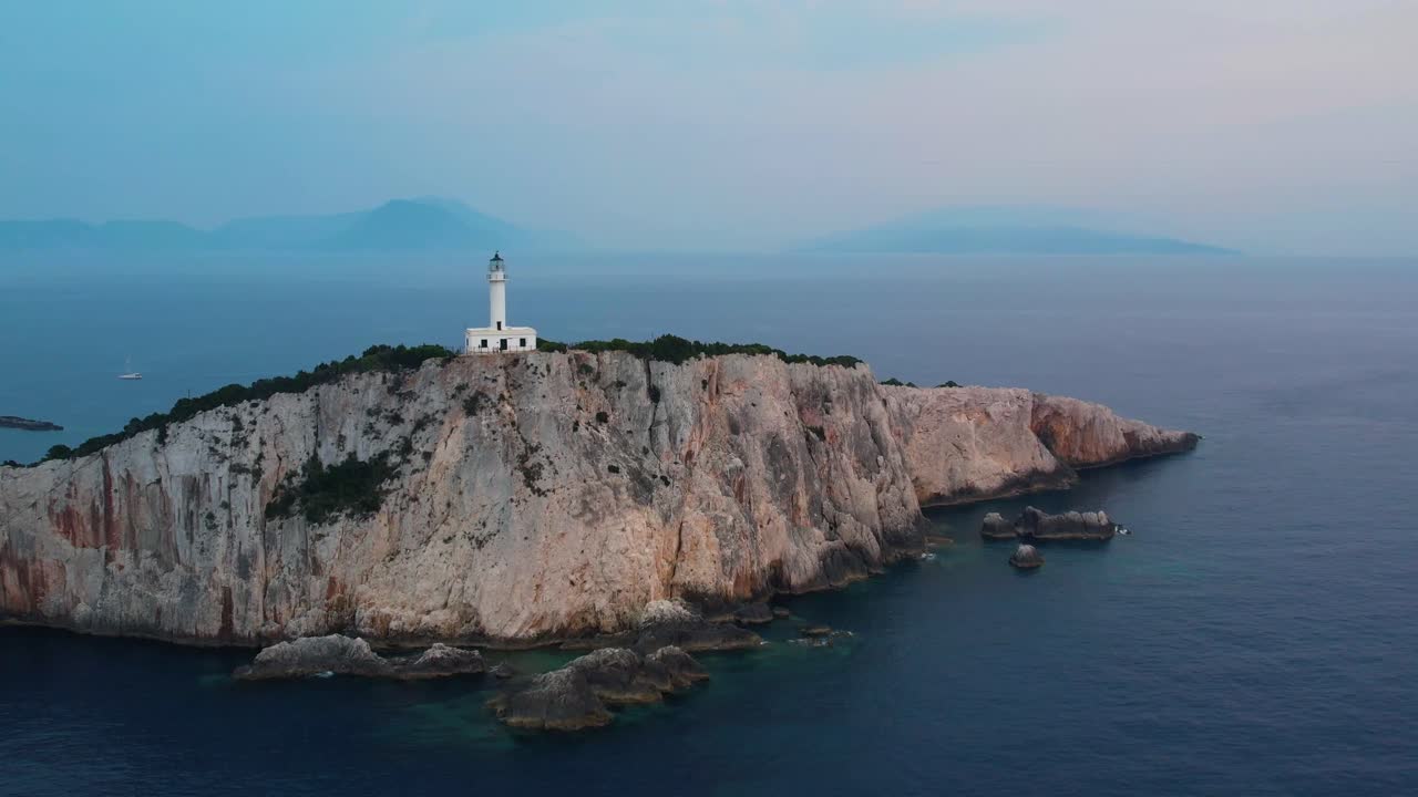 Aerial Flying Over Douk&aacute;to Lighthouse On Lefkada Cliff Edge With Misty Landscape Sea In Background