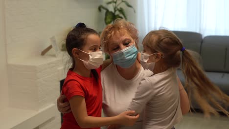 an adult woman, a retired grandmother with a granddaughters wearing a medical mask in home quarantine, because of covid-19