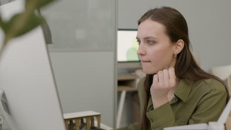 close up view of woman working using laptop sitting at desk in the office