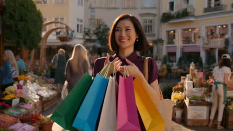 happy woman with shopping bags at a vibrant outdoor market