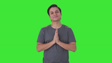 happy indian man doing namaste and greetings green screen