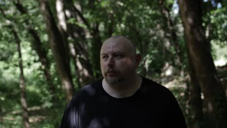 a man walking through forest trees