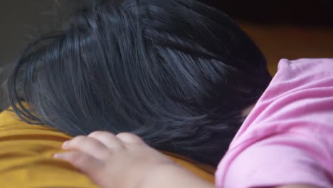 a child sleeping on a bed