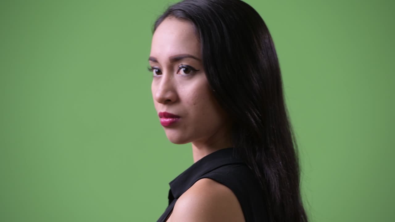 Young beautiful Asian businesswoman looking back