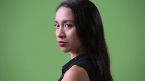 Young beautiful Asian businesswoman looking back