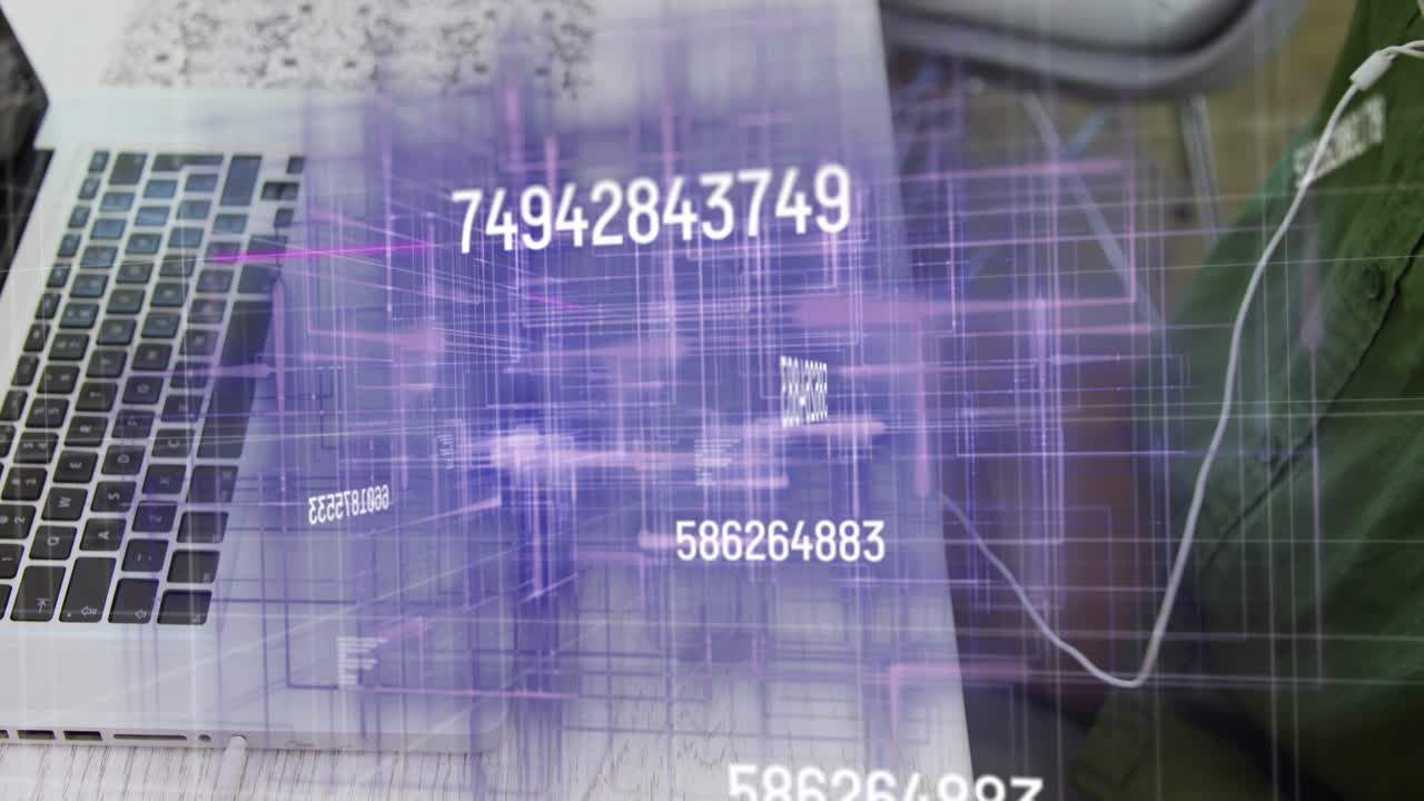 Man placing hands on laptop keyboard and typing, activating holographic numeric grid revealing data