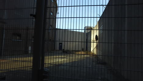 prison's basketball field behind metal mesh