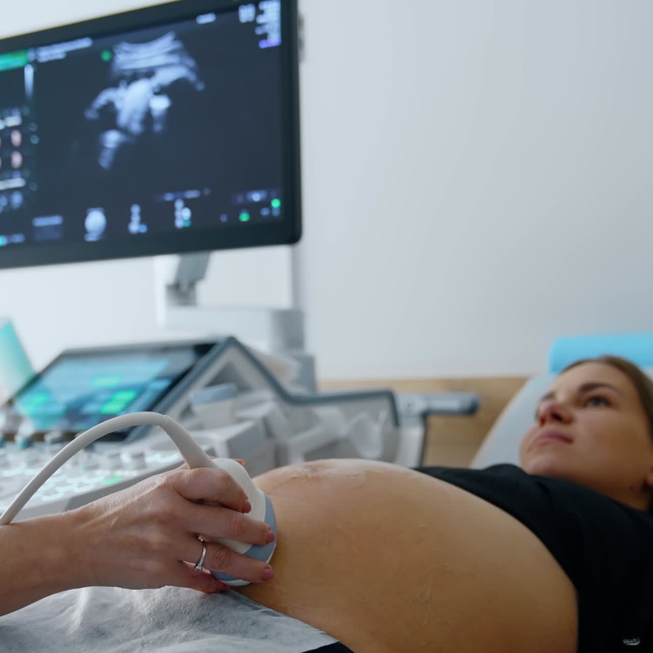Belly examining in modern hospital. Ultrasound pregnancy diagnostic