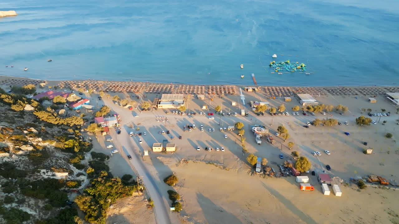 Aerial tracking shot of the Paralia Tsampika Beach, sunset in Rhodes, Greece