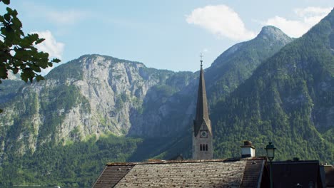 evangelical church tower in picturesque town of hallstatt in austria, cinematic