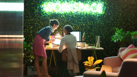 two women collaborating in a modern office