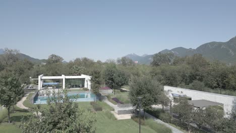 aerial establishing shot of a villa with a pool with a mountain backdrop