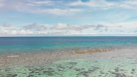 tropical shallow blue ocean waves washing up on coral in the pacific drone footage