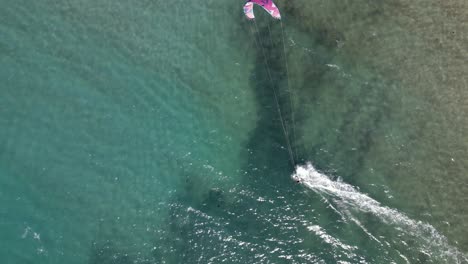 aerial top down view of a kitesurfer, water sport in the ocean, fun activity