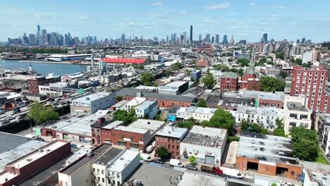 Aerial-flyover-american-neighborhood-with-different-colored-houses-in-Industry-City-District-during-bright-sunny-day---Brooklyn,NYC---Drone-wide-shot