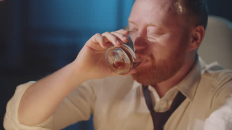 businessman drinking whiskey at night