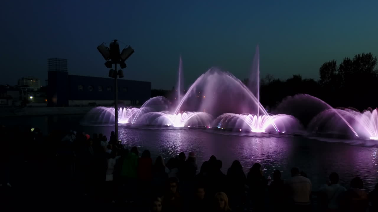 Music Fountain On The River. Aerial shot of the beautiful night performance of colorful fountains
