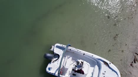 dynamic drone flight over a white motorboat