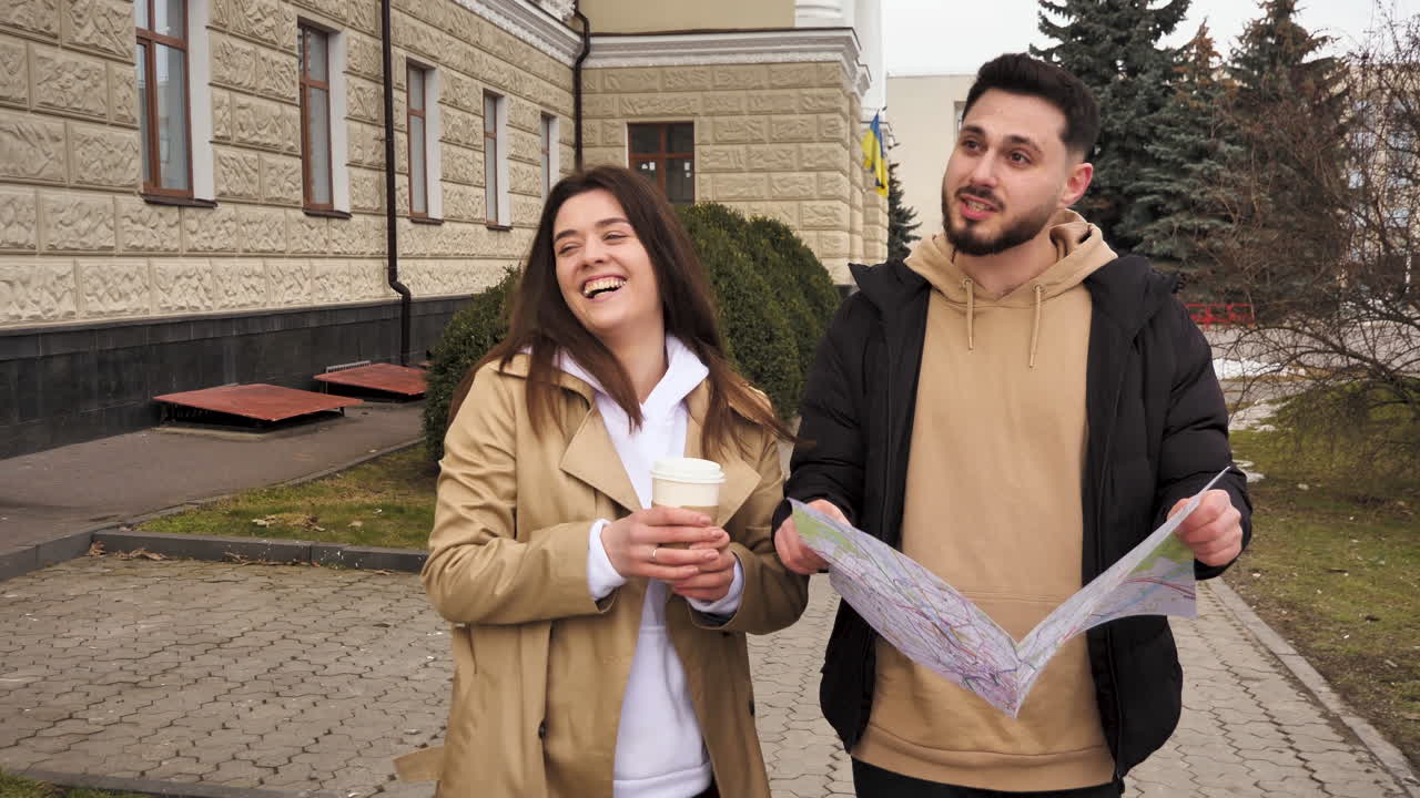 Caucasian couple checking map for directions on the street.
