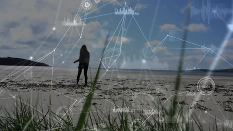 animation of network of connections with data processing over caucasian woman walking on beach