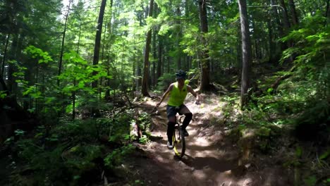 woman riding unicycle in the forest 4k