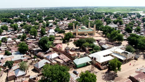 argungu town and the national mosque in kebbi state, nigeria - pull back aerial flyover