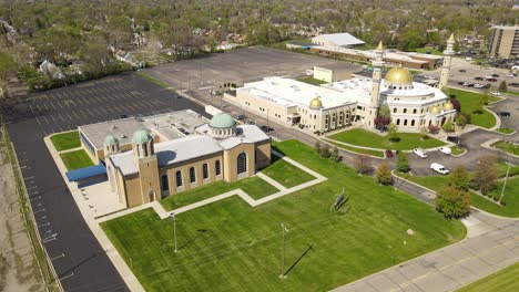 aerial orbit shot of islamic center of america side by side with christian church, dearborn michigan