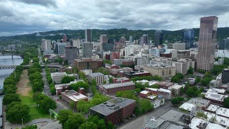 aerial drone flyover of portland oregon downtown skyline. slow approach on a cloudy day.