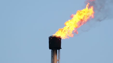 torch of gas burning fire flames from chimney pipe