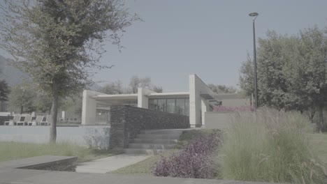 slow establishing shot of a stone walkway leading up to a private villa