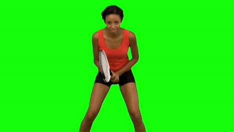 mujer jugando al tenis en la pantalla verde