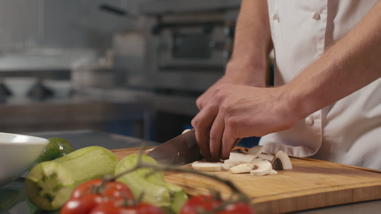 Chef Dicing Mushrooms On Cutting Board