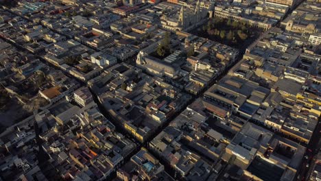 aerial wide establishing of arequipa, peru, with sprawling cityscape set against the towering misti volcano, panoramic view