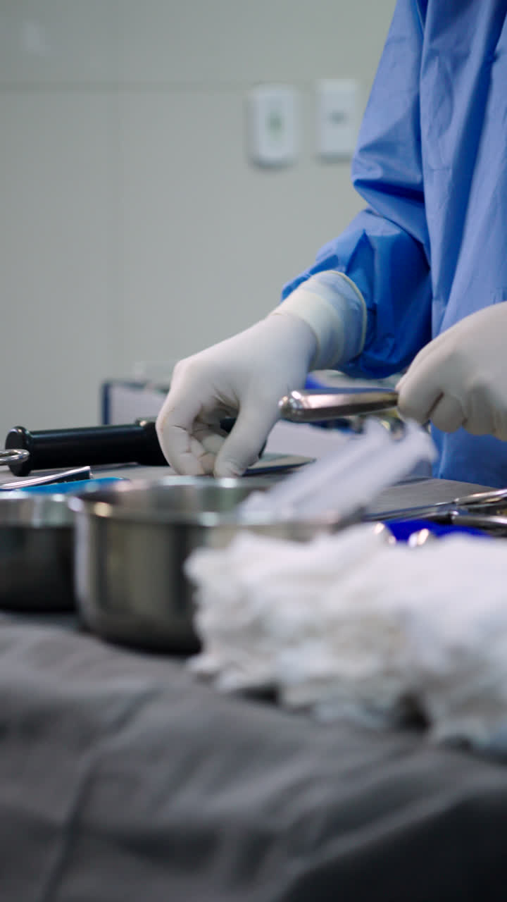 Doctor handling surgical equipment pre-surgery