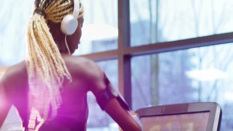 Fit-woman-with-smartphone-exercising-on-treadmill