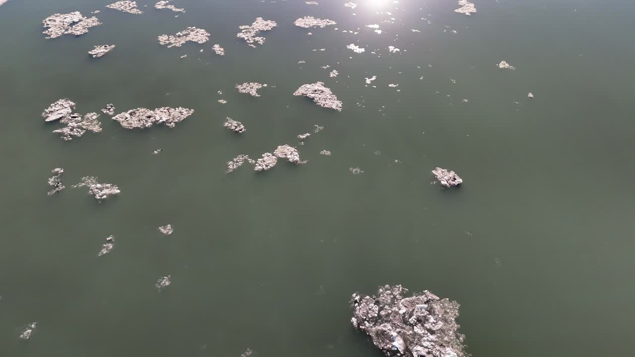 Aerial Drone Footage of Ice Blocks Flowing Along a River in Iceland