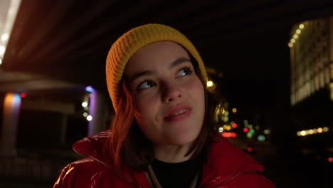 cheerful woman looking to city lights outdoor. pretty girl smiling on street.