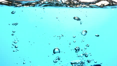 bottle falling into blue water