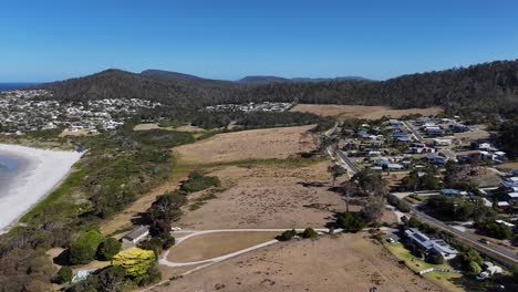 dry land near the seaside and suburban neighborhood during daytime, aerial shot