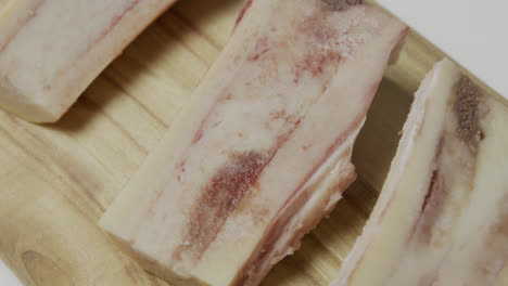 Bone-marrow-with-blood-spots-placed-on-wooden-cut-board