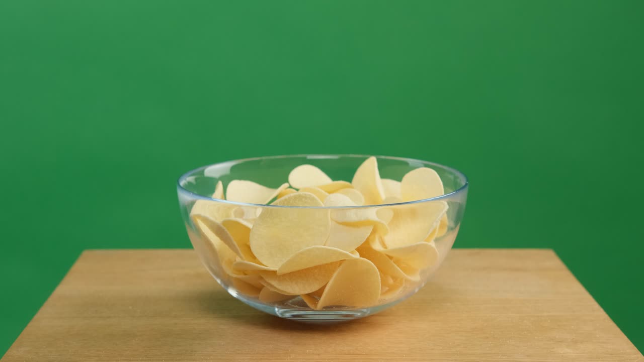 Chips fill a plate, green screen