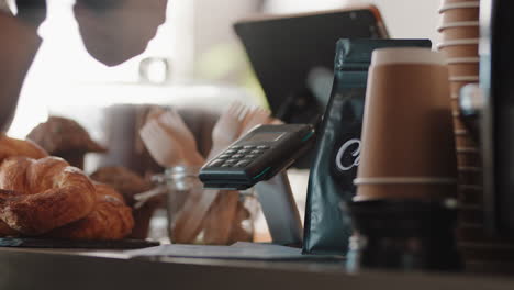 close-up-customer-making-contactless-payment-using-smart-watch-mobile-money-transfer-buying-coffee-in-cafe-enjoying-service-at-restaurant