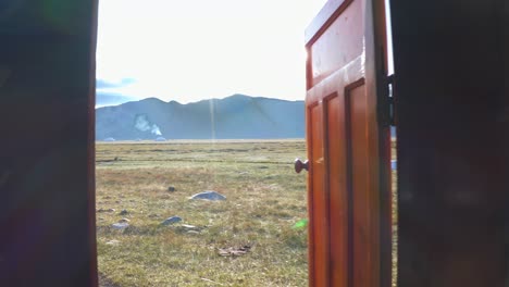 open door to a scenic steppe landscape